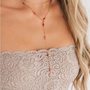 Elegant Gold Lariat Necklace with Red Accents